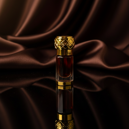 Perfume bottle with gold cap on a reflective surface with dark fabric background